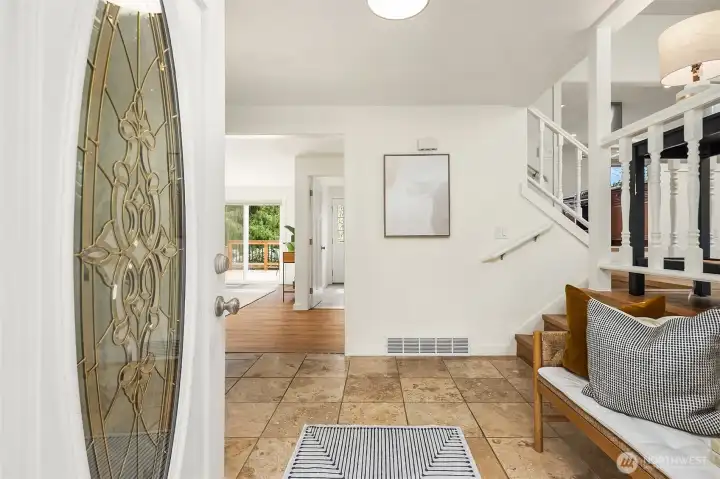 Foyer with tile entry, large coat closet and room for bench/entry table.