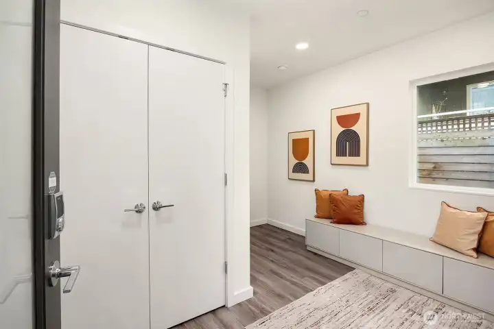 The huge entryway double closet. Notice the freshly painted interior and wood floors.