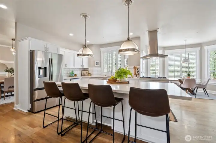 The oversized center island provides the perfect setting for casual meals, conversation, and celebrations.