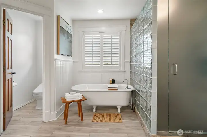 A bidet adds an extra touch of comfort and convenience to this well-appointed space.
