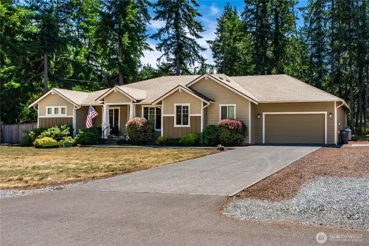 Welcoming front exterior with covered entry, mature landscaping, attached 3-car tandem garage, and easy access to the detached shop. Welcoming front exterior with covered entry, mature landscaping, attached 3-car tandem garage, and easy access to the detached shop.