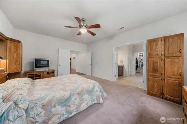 Primary suite view highlighting the generous bedroom layout, ensuite bathroom access, walk-in closet, and comfortable single-level design. Primary suite view highlighting the generous bedroom layout, ensuite bathroom access, walk-in closet, and comfortable single-level design.