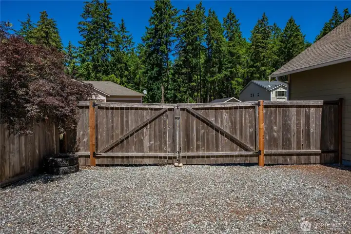 Fenced gate and gravel parking area adding privacy, security, and flexible use for extra vehicles, trailers, or outdoor storage needs. Fenced gate and gravel parking area adding privacy, security, and flexible use for extra vehicles, trailers, or outdoor storage needs.