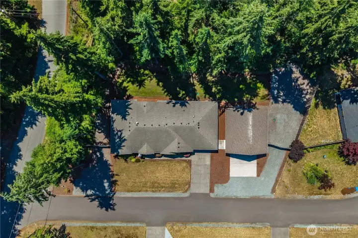 Top-down aerial view showing the property layout, rambler footprint, detached shop, yard space, and parking areas. Top-down aerial view showing the property layout, rambler footprint, detached shop, yard space, and parking areas.