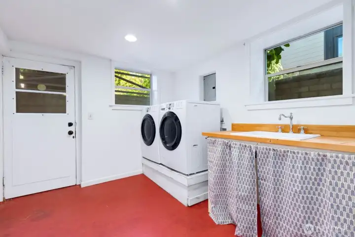 The laundry room has so much to offer. Storage, a laundry sink, extra space, and s separate entrance to the lower level. If you want an ADU downstairs, this might be where you'd put a kitchen! The laundry room has so much to offer. Storage, a laundry sink, extra space, and s separate entrance to the lower level. If you want an ADU downstairs, this might be where you'd put a kitchen!