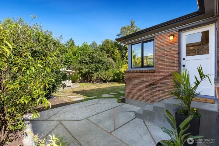 The door off the kitchen leads to this patio and the fully-fenced yard. The door off the kitchen leads to this patio and the fully-fenced yard.