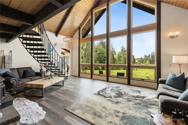 Incredible views of the property and sunsets through the large living room windows. New LVP in the living room and in the main floor primary bedroom.