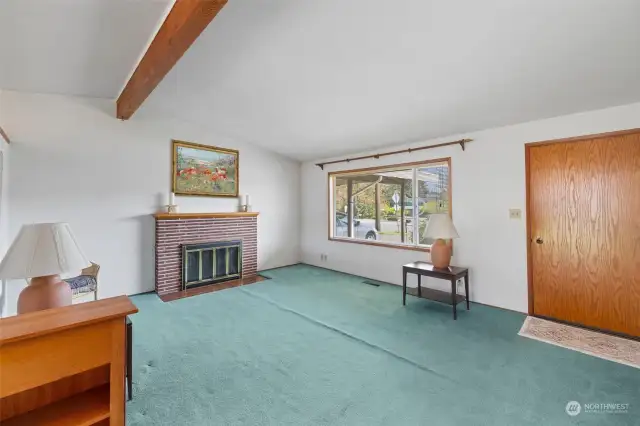 Living room with hardwood floors under carpet