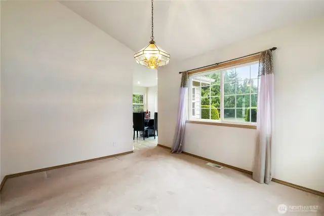 dinning room looking to the back yard and into the kitchen with eating area