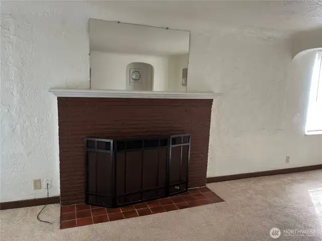 Wood burning fireplace in living room.
