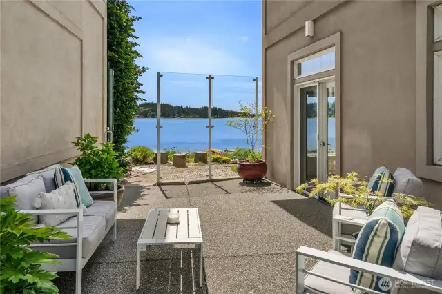 Patio area with storm glass to enjoy year-round outdoor use.  There are also gardens that are private to this home along with HOA covered general landscaping.