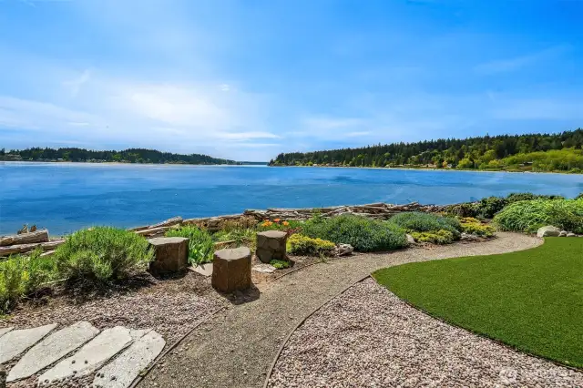 Outside the storm door on the patio is a private yard and natural-looking enforced bulkhead.