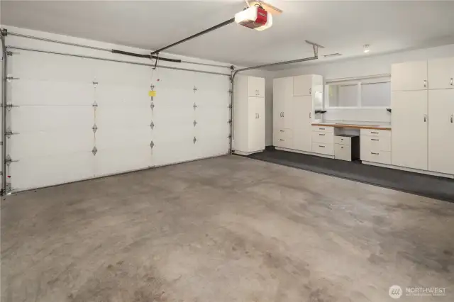 Detached 2 car garage has space for a workbench and lots of storage.