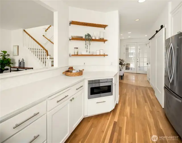 Front door leads into entry with staircase, back bedroom, a 3/4 bath and the main living area.