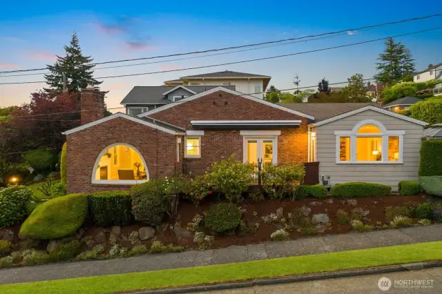 Desirable Magnolia home situated on a southwest facing corner lot with timeless curb appeal and a stunning arched window that floods the interior with natural light and captures Sound views.