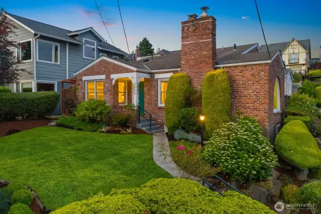 Desirable Magnolia home situated on a southwest facing corner lot with timeless curb appeal and a stunning arched window that floods the interior with natural light and captures Sound views.