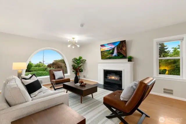 Stunning arched window that floods the interior with natural light and captures Sound views