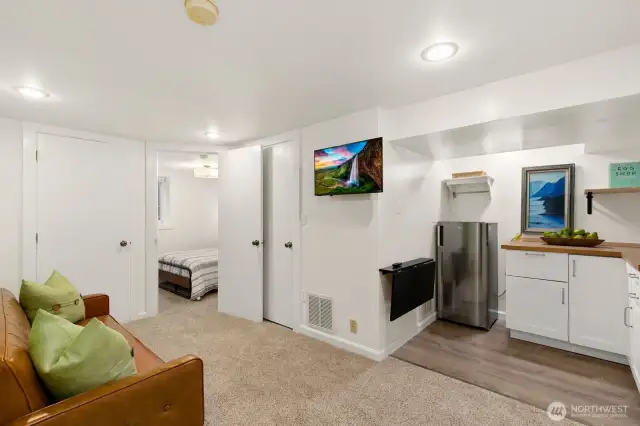 The lower level features a private guest suite with fourth bedroom, kitchenette, and ¾ bath, offering excellent separation of space.