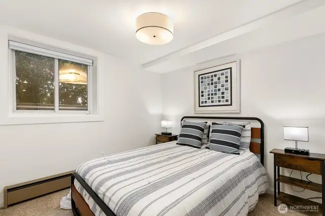 The lower level features a private guest suite with fourth bedroom, kitchenette, and ¾ bath, offering excellent separation of space.