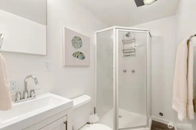 The lower level features a private guest suite with fourth bedroom, kitchenette, and ¾ bath, offering excellent separation of space.