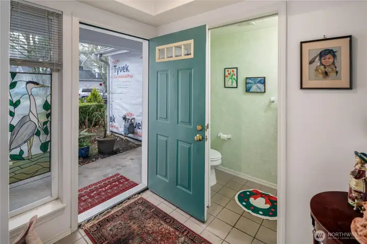 Large entry with convenient half bath.
