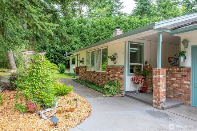 Front entryway sidewalk. There is a front entrance as well as a covered breezeway entrance.  The red brick accents are beautiful!