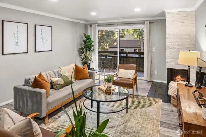 Living room has a large partially covered patio with storage attached.