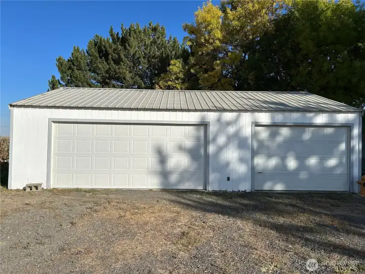Garage is 24x36.  Double car parking with opener on the left and built in shelves for storage.  Single car on the right which is completely finished inside for shop area.