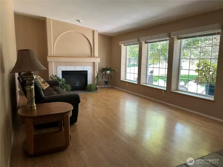 Formal living off front entrance.  Propane fireplace with heatilator provides heat if power is out.  Large picture windows provide everchanging views and so much natural light.  Flooring is UV protected laminate.