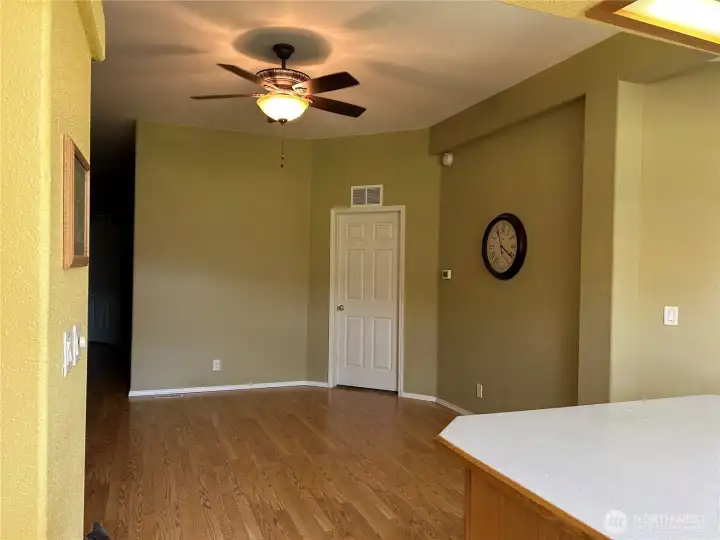 Dining area.  Hallway to 2 bedrooms and bath on the left.  Door leads to the primary bedoom.