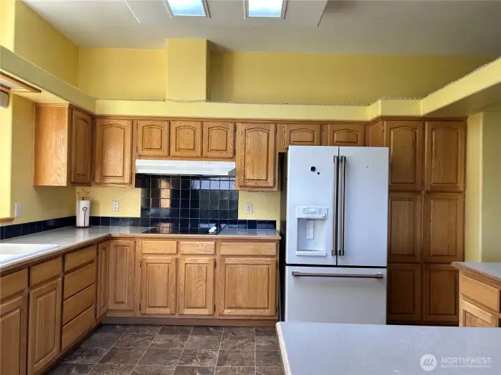 You will never lack storage in this kitchen. Window faces south.