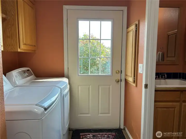 Utility room with back door exit.  1/2 bath on the right.  Large utility sink.