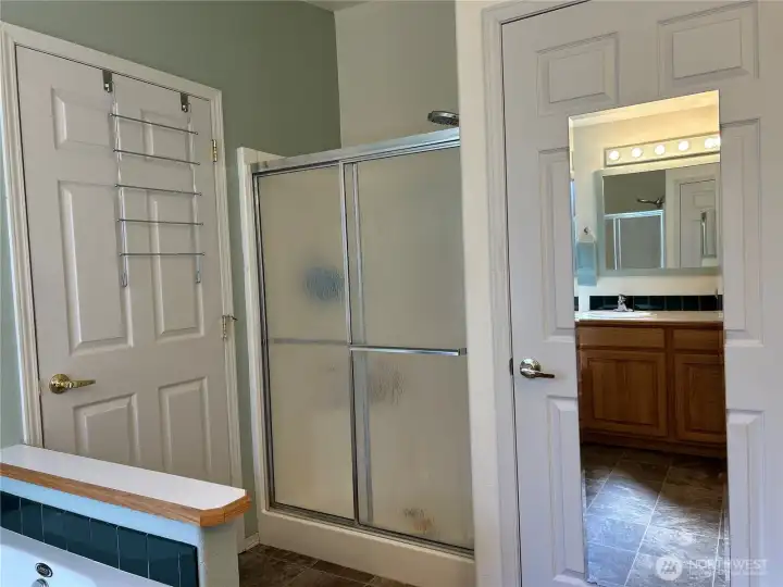 Primary bath with extra large shower.  Door to water closet
