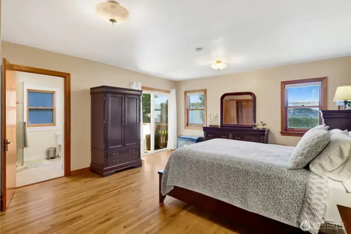 The primary bedroom suite is on the main level and has access to the deck and an updated 3/4 ensuite bathroom