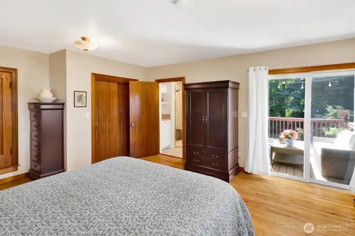 The primary suite has access to the deck and a newly refreshed bathroom