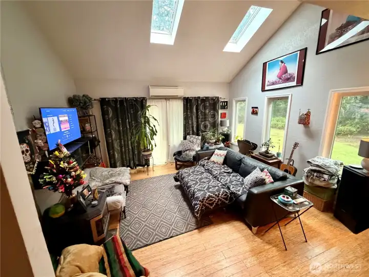 Living room with high ceilings and skylights.