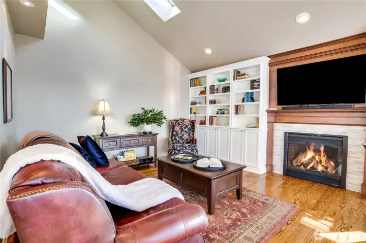 Cozy family room features fireplace and built ins making a beautiful place to unwind.