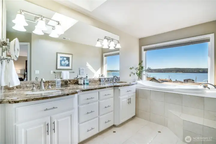 Featuring dual vanities, a deep soaking tub, and a beautifully tiled walk-in shower—designed for indulgence.