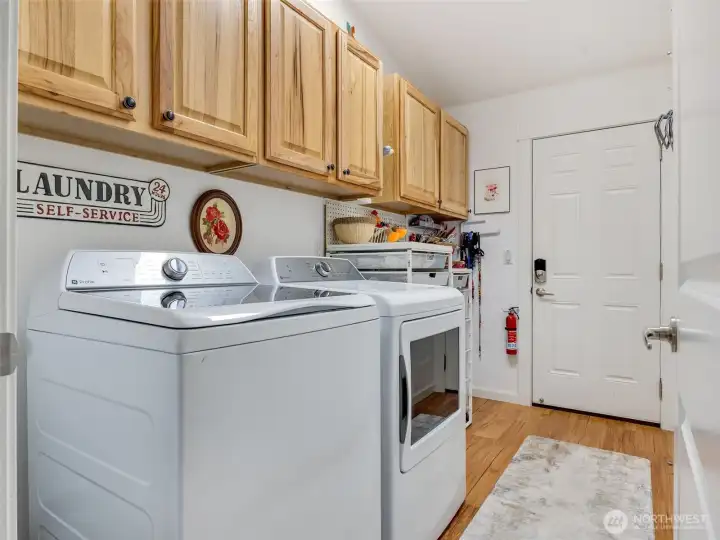 Laundry area leading out to an additional storage space and 2 car garage.