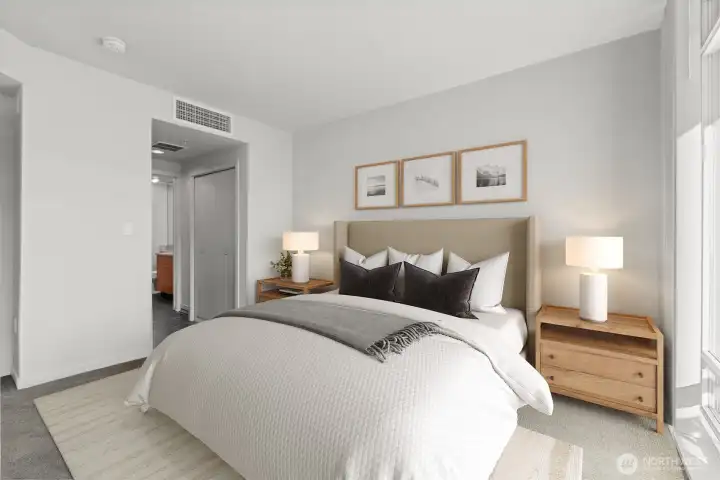 Primary bedroom w/ ensuite bath & own balcony (virtually staged)