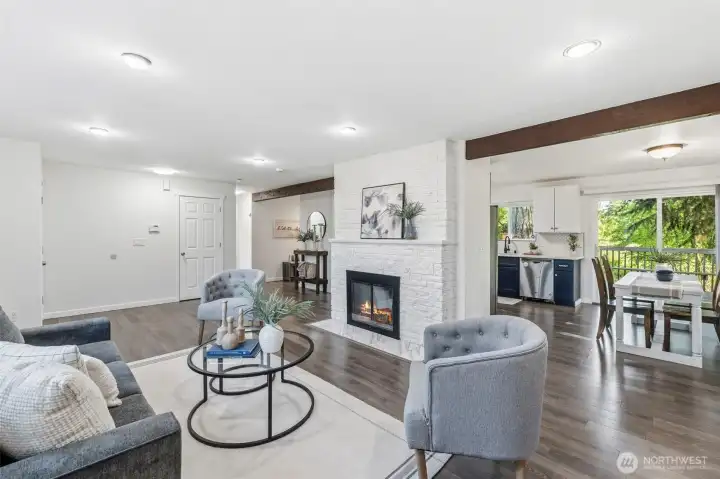 The living room is connected by the eat in space which serves as the dining area. This isn't open concept but it also isn't a fully enclosed kitchen.