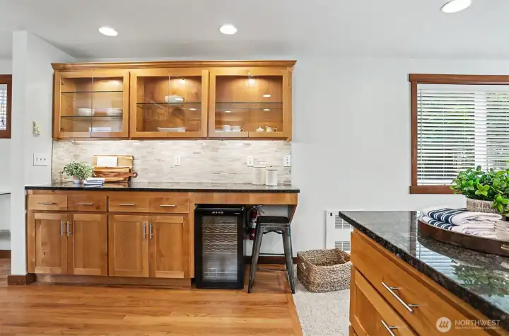 East wall houses a great side bar with lighted, glass cabinetry to display your favorite pieces.
