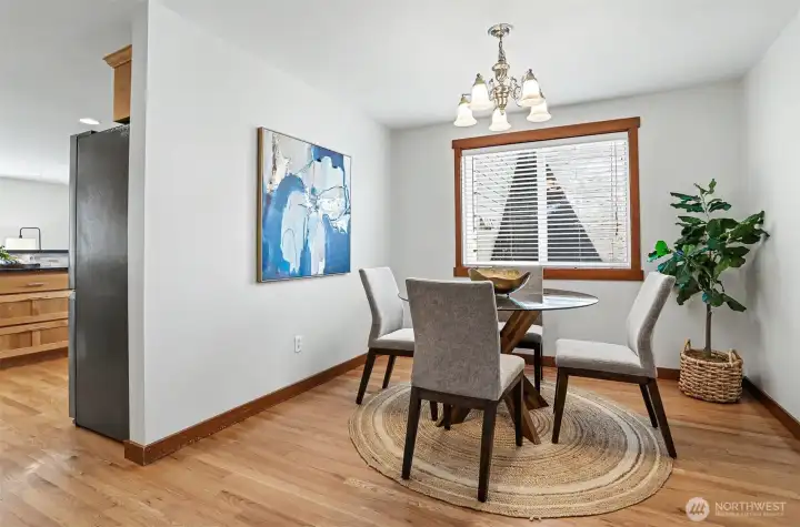 Rich hardwood floors lead from kitchen to dining room.