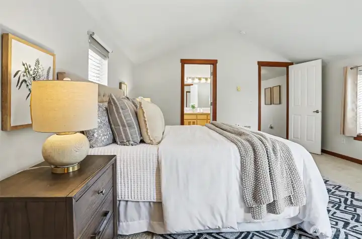 Primary lives large with vaulted ceilings & lots of light.