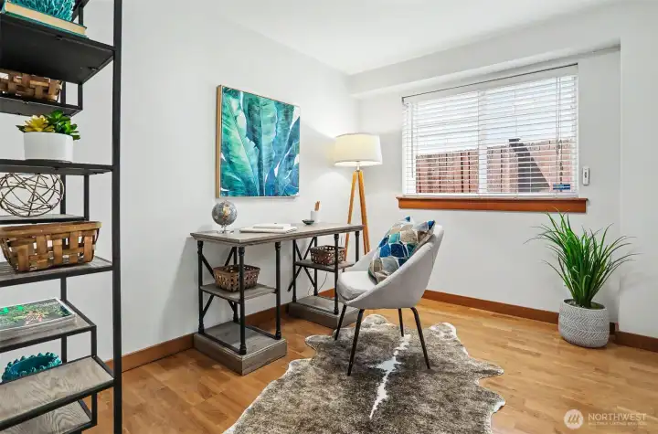 Second of two bedrooms on the first floor, staged as home office.