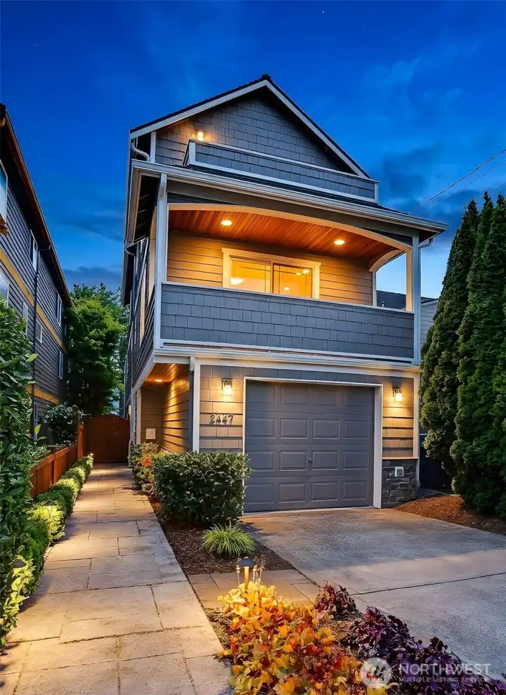 Strategically placed outdoor and landscape lighting, give the home a warm glow and makes for an inviting approach.