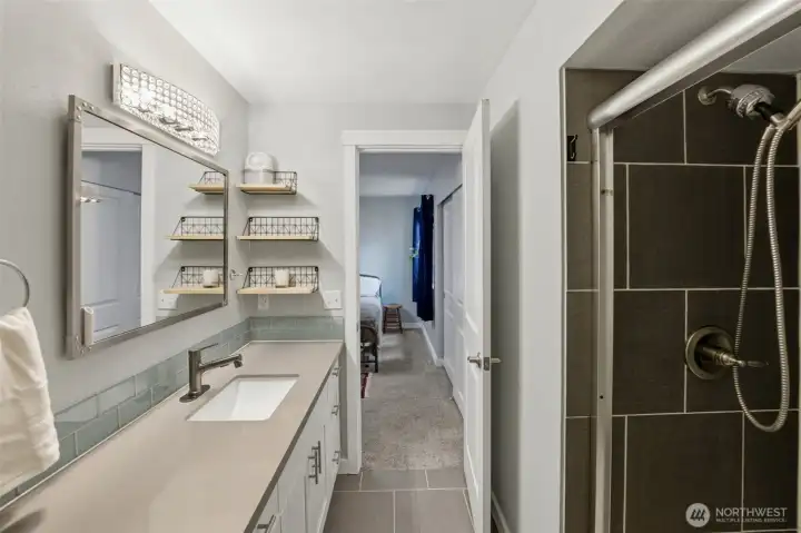 Primary bath features lots of counter space and a large tiled shower.