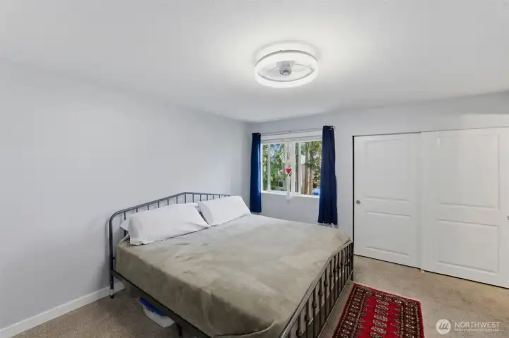 Primary bedroom on upper level with backyard view and private ensuite bath.