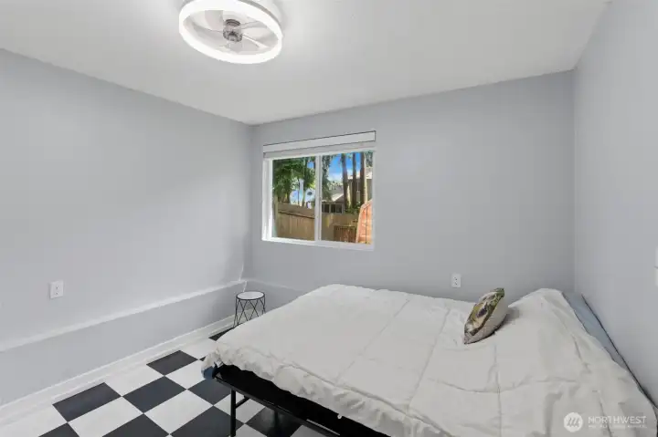 Lower level bedroom/flex room looks out into the treed backyard.