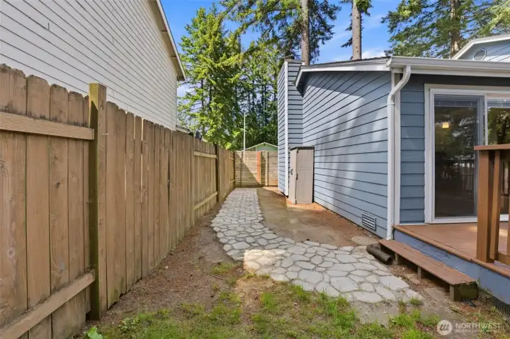 Cement walkway from deck to front gate is a stylish touch.